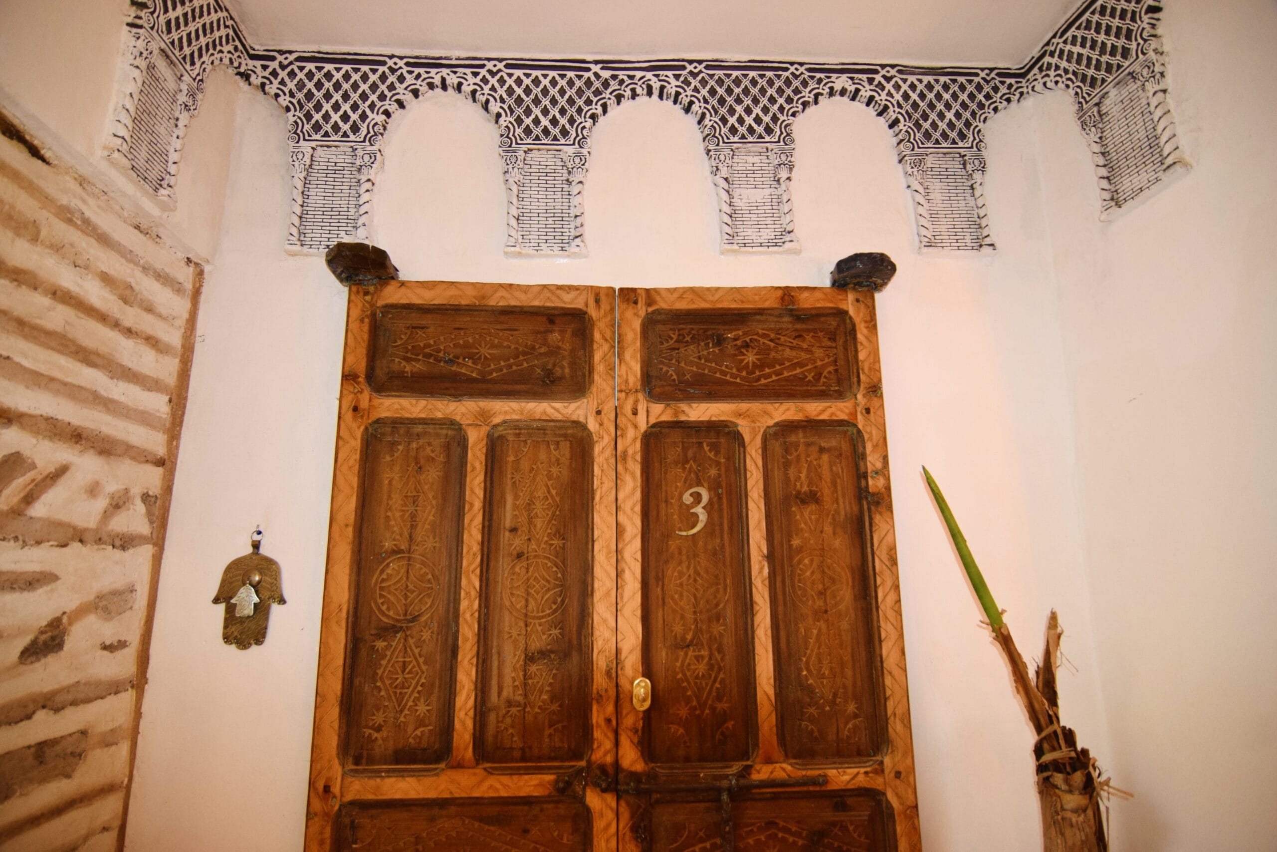 A room with a double bed and a patio